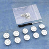 A clear plastic bag contains an instant no-sew snap button kit with various silver buttons and a black tool for fastening loo