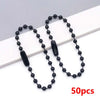 A string of black ball beads is displayed on a white background, ready for jewelry making.