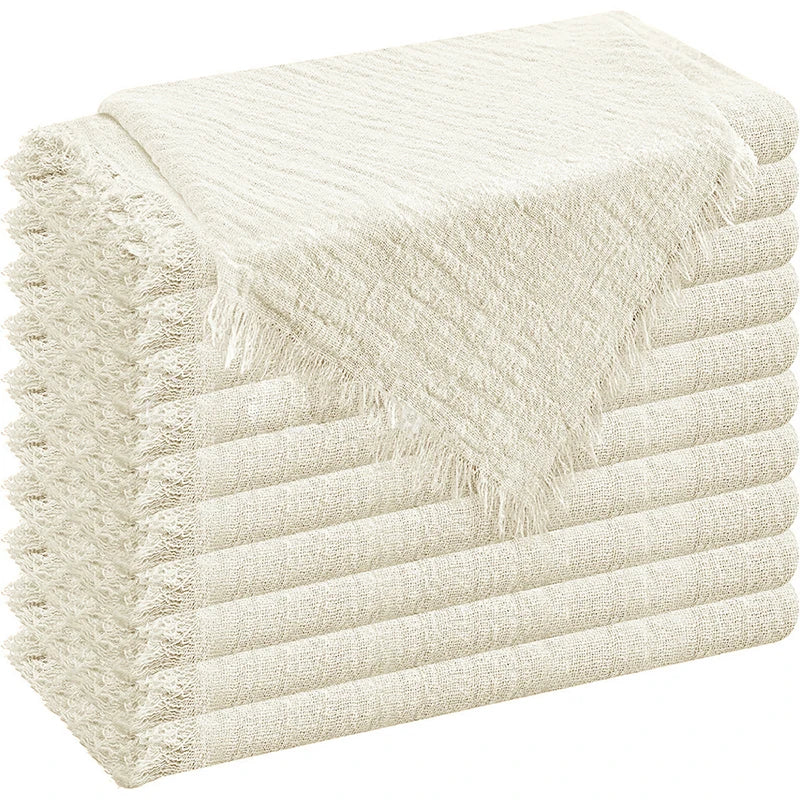A stack of six raw-edge, beige polyester cloth napkins folded neatly.