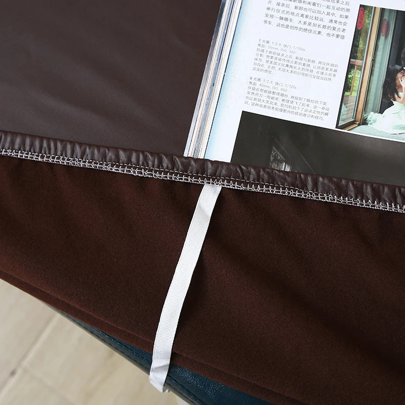 A dark brown waterproof PU stretch bench cover with a white elastic edge is shown on a surface.