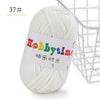 A ball of white soft T-shirt yarn for crochet and knitting is shown next to a wire basket.