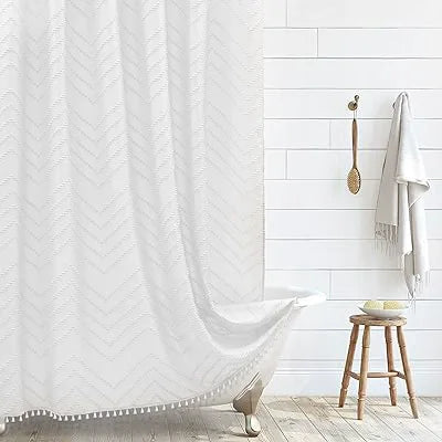 White boho waterproof shower curtain with a chevron pattern hanging on a white tiled wall