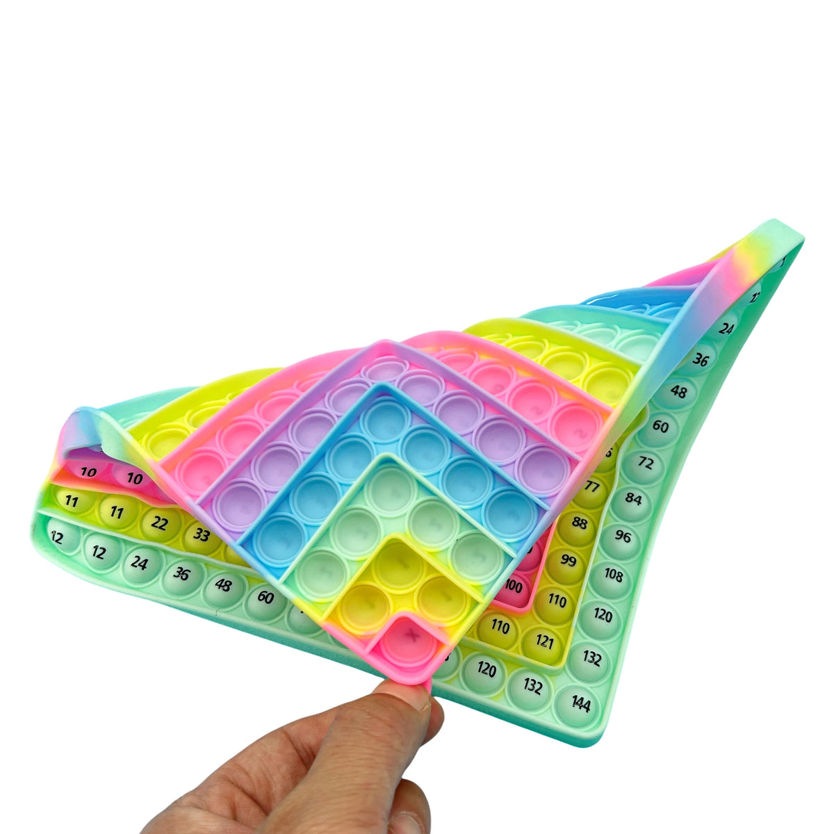 A hand holds a colorful multiplication practice math game board with 12x12 times table learning activity.