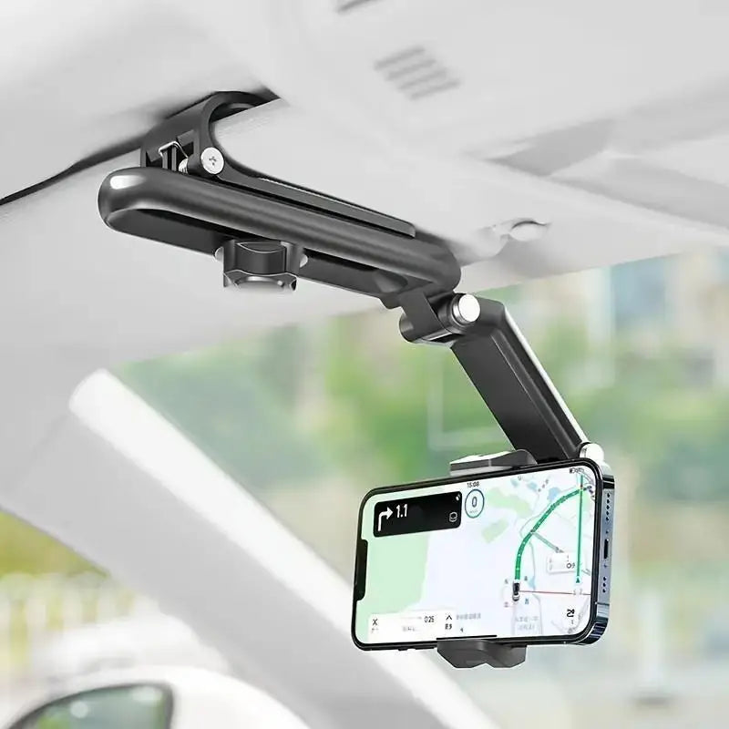 A black phone holder is mounted on a car visor, designed to hold a smartphone for viewing.