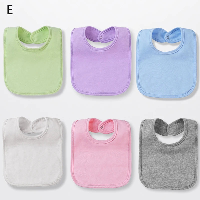 A set of six cotton bandana bibs in various pastel colors including green, purple, blue, and pink.