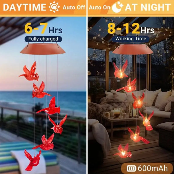Red cardinal wind chimes with LED lights hanging in a nighttime outdoor setting