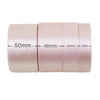 Roll of light pink satin ribbon showing various widths from 50mm down to 20mm.