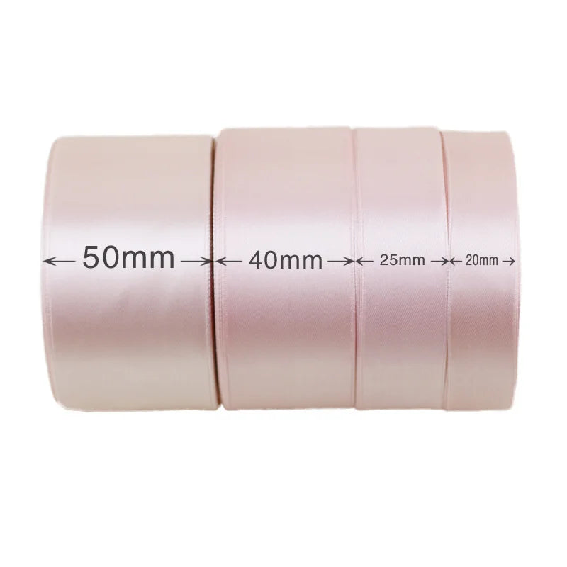 Roll of light pink satin ribbon showing various widths from 50mm down to 20mm.