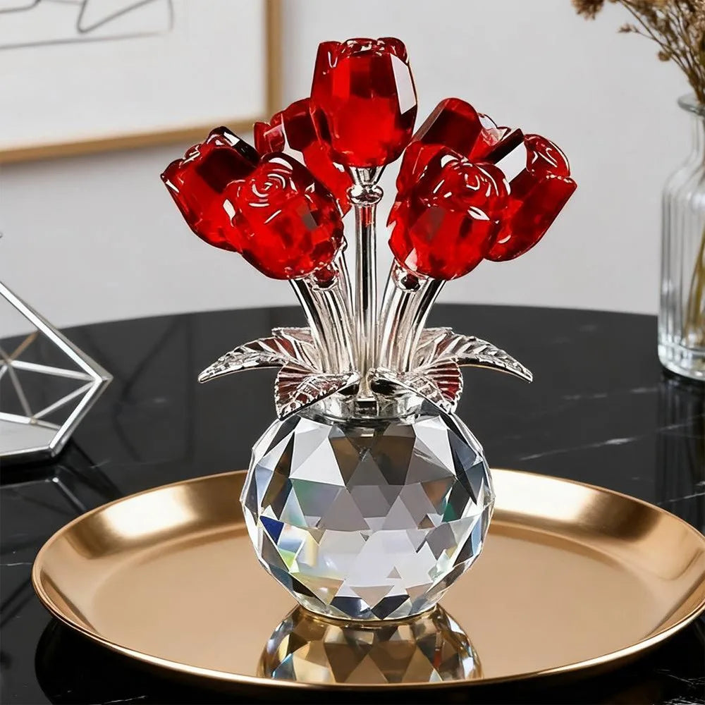 A crystal rose sculpture with a bouquet of red reflective roses displayed on a gold plate.