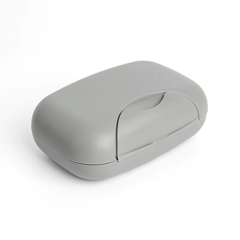 A compact, gray leak-proof travel soap box with a hinged lid.