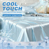 A close-up of a silky blue cooling fitted sheet on a bed, emphasizing its cool touch and breathable features.