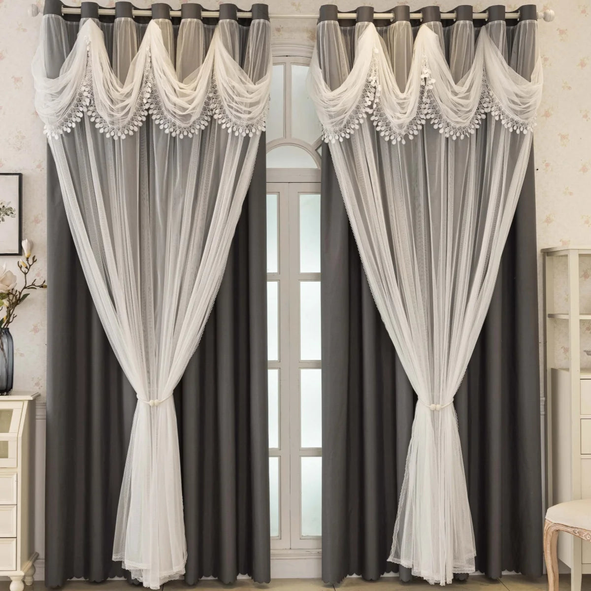 Gray blackout curtains with white trim and wave pattern hanging in a window frame.