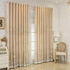 Cream embroidered double layer blackout curtain panels hanging in a bright room.