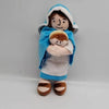 A soft plush doll depicting a mother and child, dressed in blue fabric and white clothing.
