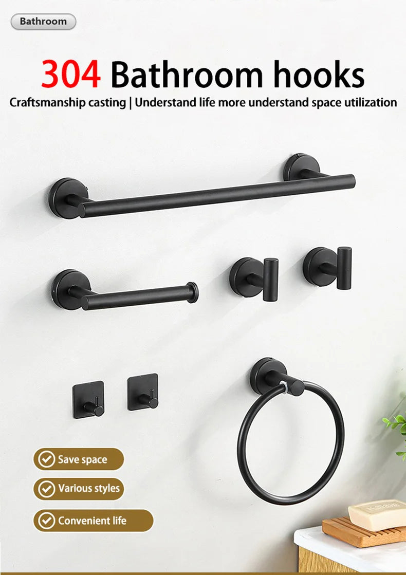 A set of black bathroom hooks and a towel ring displayed on a white wall.