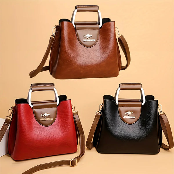 A brown leather vintage crossbody tote bag with multiple pockets shown in a studio setting.