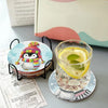 A DIY diamond art coaster set with a metal stand is displayed next to a glass of lemon and mint.