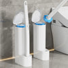 A white disposable toilet brush and holder set with a blue replaceable head, shown against a gray tiled wall.