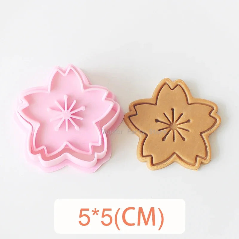 A set of two pink and tan floral cookie cutters featuring cherry blossom, peach blossom, and sunflower designs.