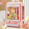 A pink mini claw crane machine for kids with lights and music is shown on a table.