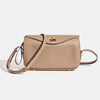 A beige genuine leather square crossbody bag with a gold lock and leather strap.