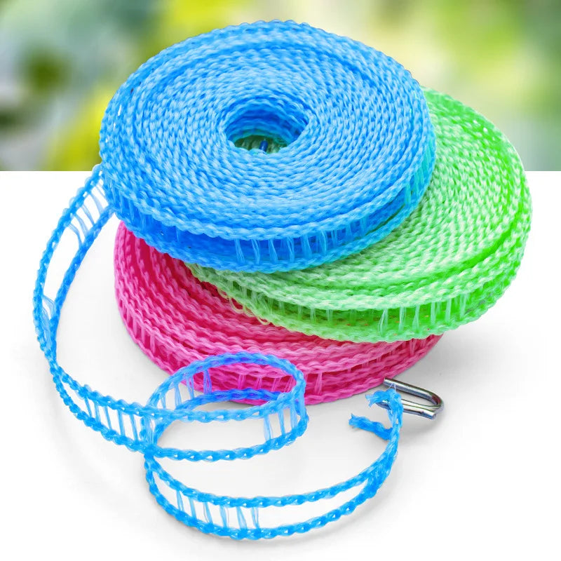 Blue, pink, and green portable windproof clothesline string coiled on a white surface.