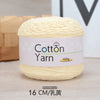 A skein of light yellow cotton yarn labeled Cotton Yarn 100g with a measurement of 16 cm.