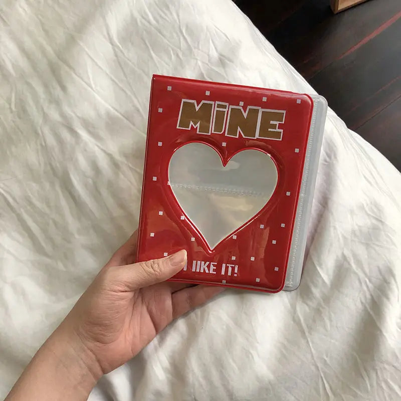 A red mini photo album with a heart-shaped clear window and text that reads I LIKE IT