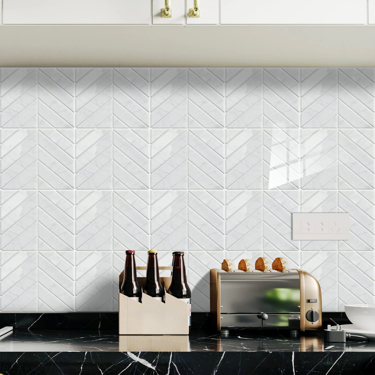 White herringbone marble peel-and-stick wall tiles displayed above a black countertop.