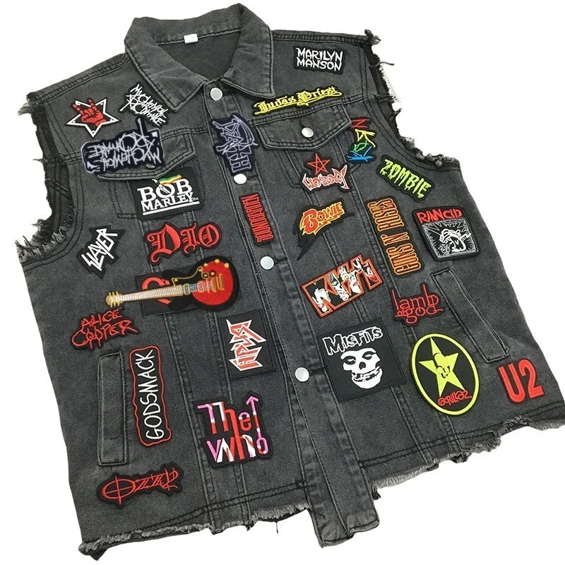 A dark denim jacket covered with numerous embroidered rock band patches and emblems.