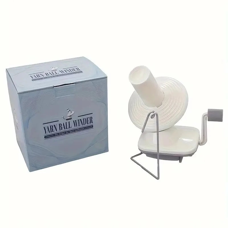 A compact hand-operated yarn ball winder in light gray packaging and a white plastic device.
