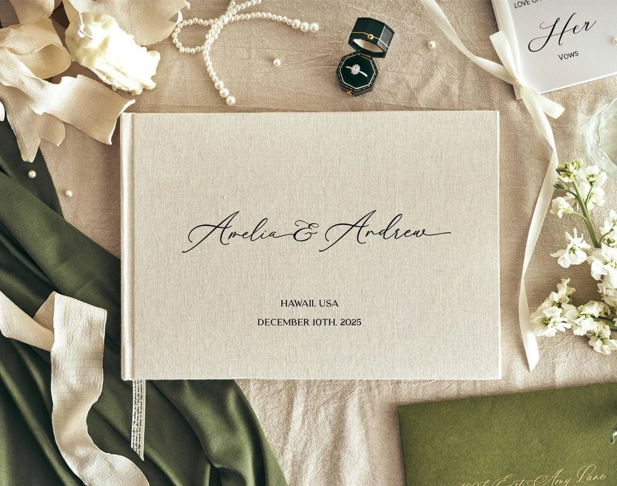 A personalized linen wedding guest book with a light beige cover, featuring elegant script and floral accents.