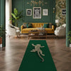 A dark green runner rug with a silver leopard print design placed on a wooden floor in a richly decorated room.