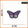 A purple butterfly embroidered iron-on patch with black detailing.