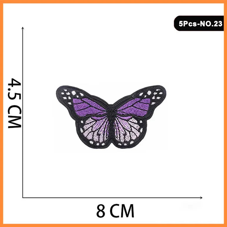 A purple butterfly embroidered iron-on patch with black detailing.