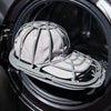 A gray cap protector cage is placed inside the drum of a washing machine.