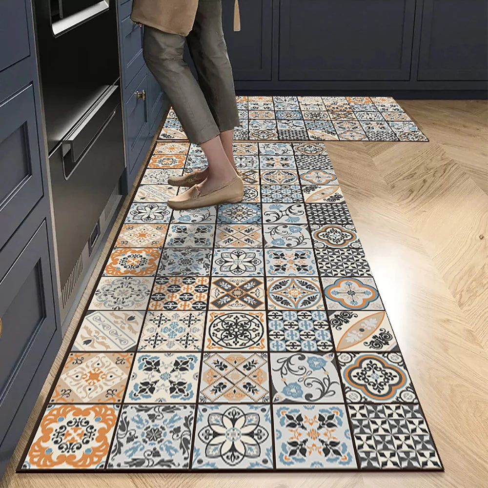 A long rectangular floor mat featuring a geometric pattern of beige, gray, and blue tiles placed on a light wood floor.