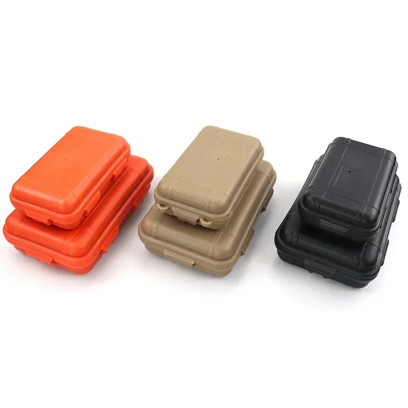 Three waterproof sealed storage boxes in orange, tan, and black stacked together.