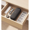 A dark gray electric screwdriver set with various bits and a clear storage case inside a wooden box.
