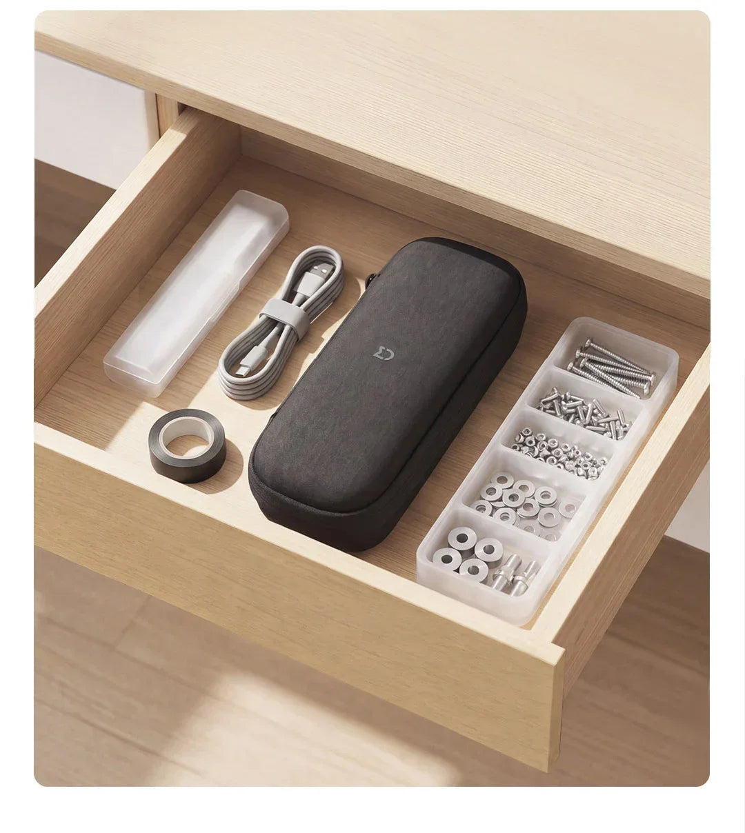 A dark gray electric screwdriver set with various bits and a clear storage case inside a wooden box.