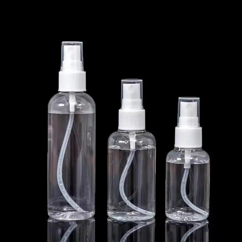 Clear portable refillable travel spray bottle with white pump and clear liquid