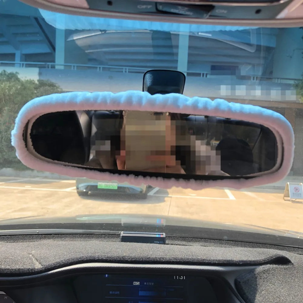 Rearview mirror covers with a plush bear and pig design installed in a car interior.