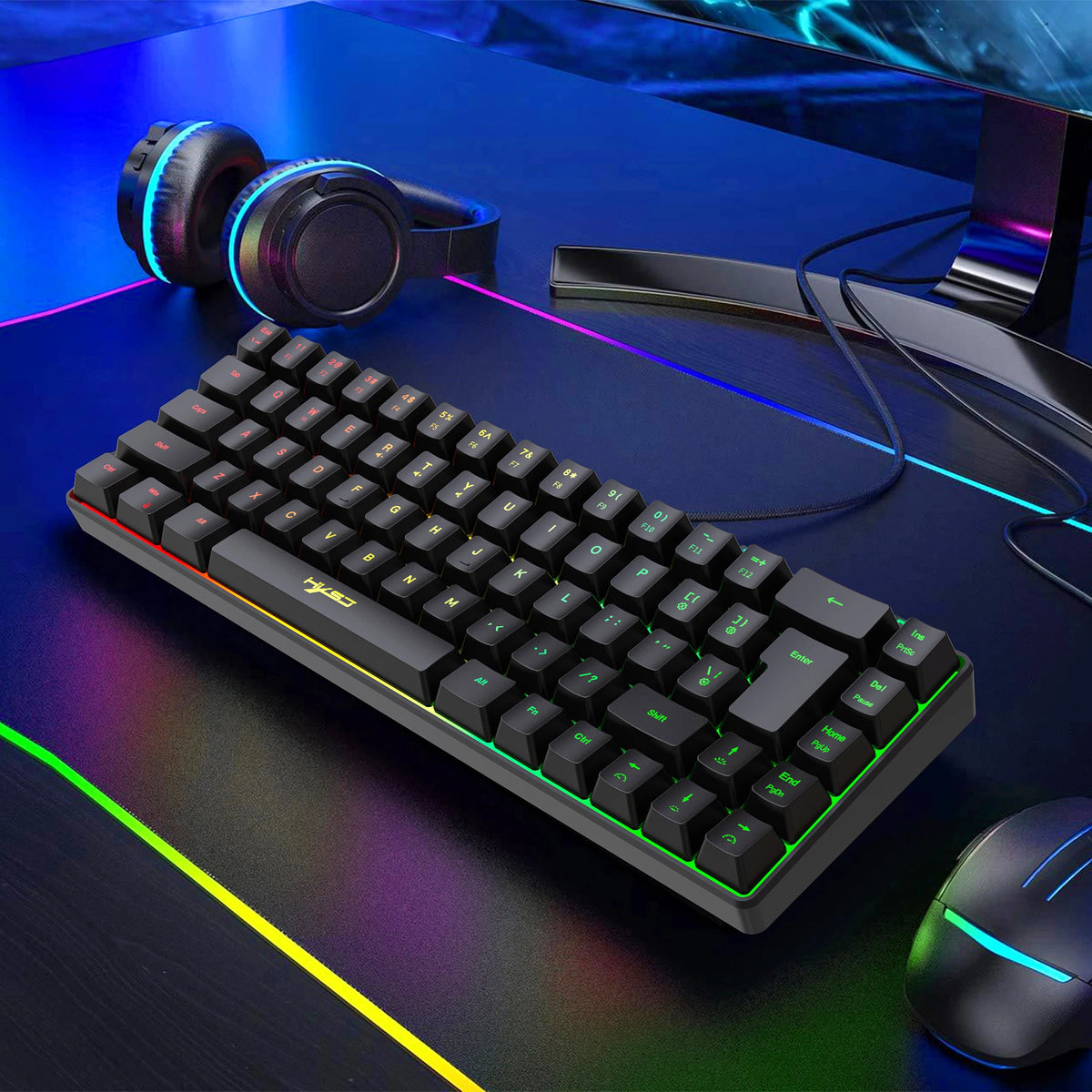A compact 68-key RGB wired gaming keyboard with headphones and a mouse displayed on a dark surface.