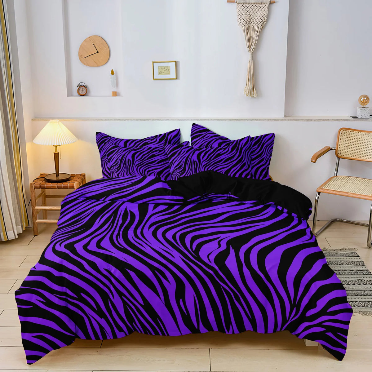 A purple and black zebra print duvet cover set displayed on a bed with a wooden nightstand and wall decor.