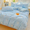Light blue floral duvet cover set with a matching flat sheet and pillows on a bed.