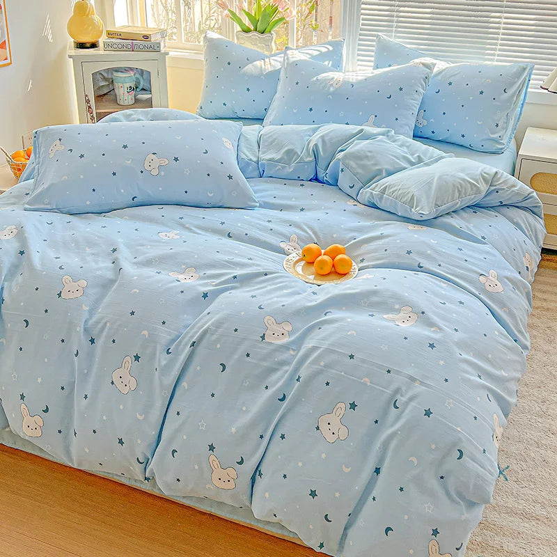 Light blue floral duvet cover set with a matching flat sheet and pillows on a bed.