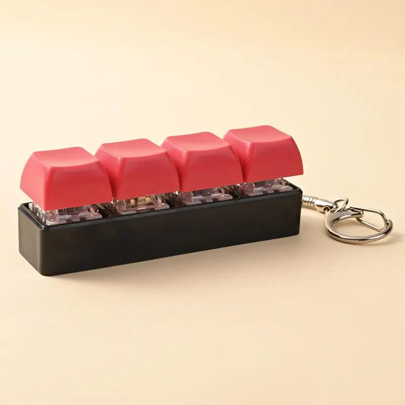 A black LED mechanical keychain fidget toy with pink and red custom keycaps.