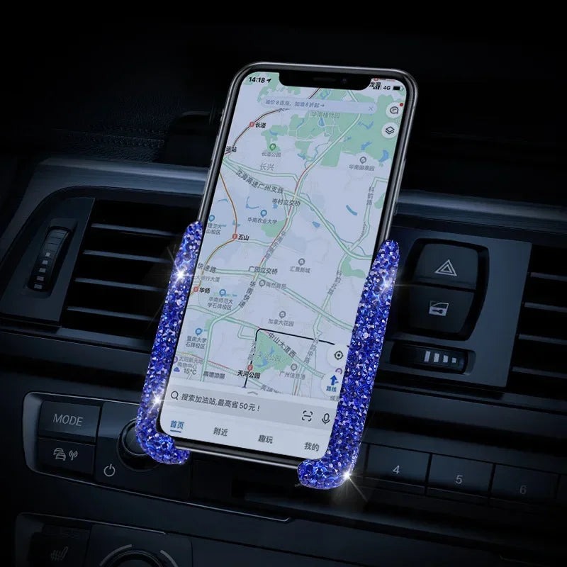 A smartphone displaying a map is held in a car vent phone holder with blue LED lights.