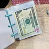 A clear plastic binder with an envelope containing a $40 US bill and a white sheet of paper.