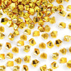 A pile of gold acrylic crushed ice gems used for vase fillers and decor.